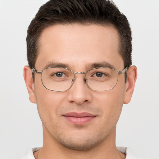 Joyful white young-adult male with short  brown hair and brown eyes