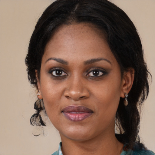Joyful black adult female with medium  black hair and brown eyes