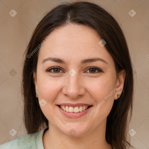 Joyful white adult female with medium  brown hair and brown eyes