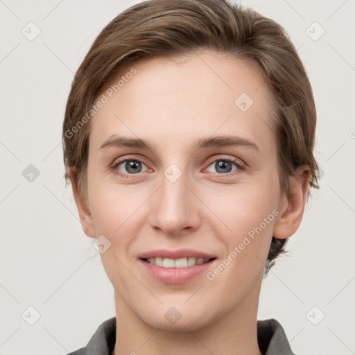 Joyful white young-adult female with short  brown hair and grey eyes