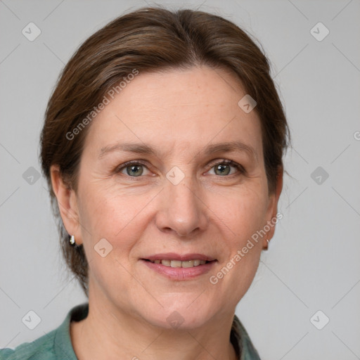 Joyful white adult female with medium  brown hair and grey eyes