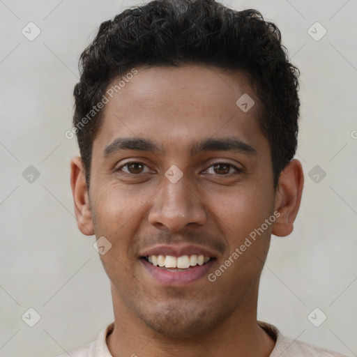 Joyful latino young-adult male with short  brown hair and brown eyes