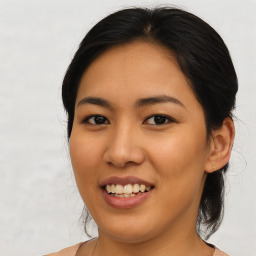 Joyful asian young-adult female with medium  brown hair and brown eyes