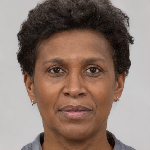 Joyful black adult female with short  brown hair and brown eyes