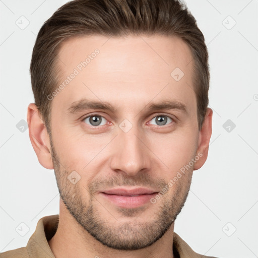 Joyful white young-adult male with short  brown hair and grey eyes