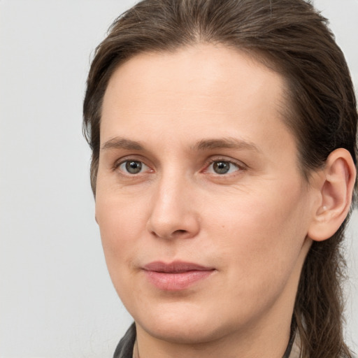 Joyful white young-adult female with long  brown hair and grey eyes