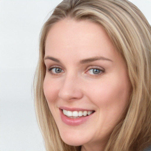 Joyful white young-adult female with long  brown hair and blue eyes