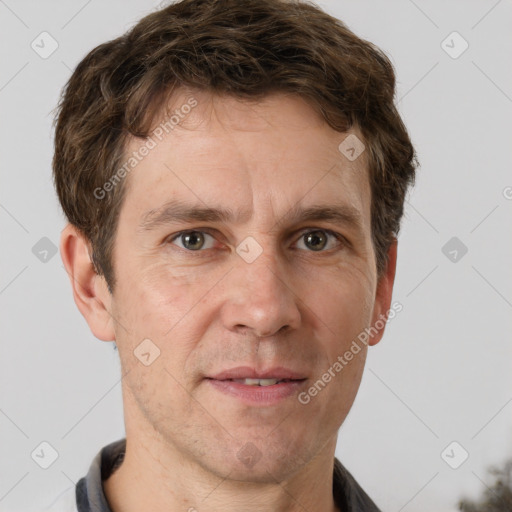 Joyful white adult male with short  brown hair and grey eyes