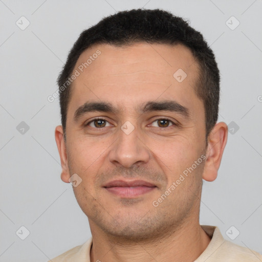 Joyful white young-adult male with short  black hair and brown eyes