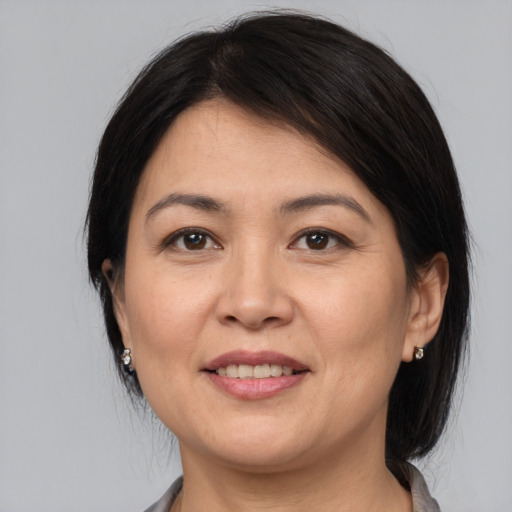 Joyful white adult female with medium  brown hair and brown eyes