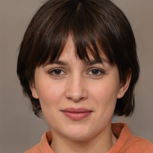 Joyful white young-adult female with medium  brown hair and brown eyes