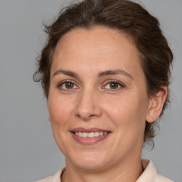 Joyful white adult female with medium  brown hair and brown eyes