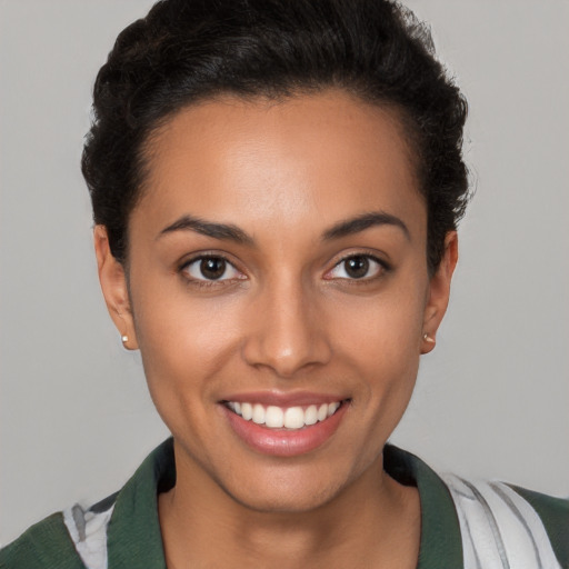 Joyful latino young-adult female with short  brown hair and brown eyes