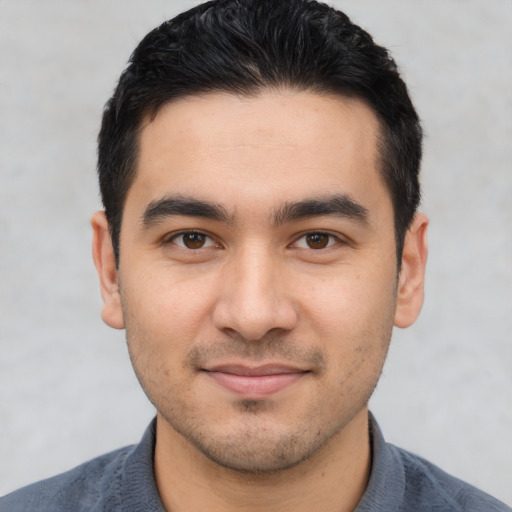 Joyful asian young-adult male with short  black hair and brown eyes