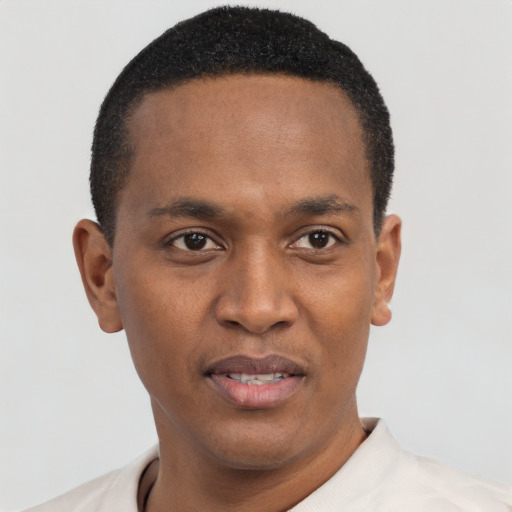 Joyful black young-adult male with short  black hair and brown eyes