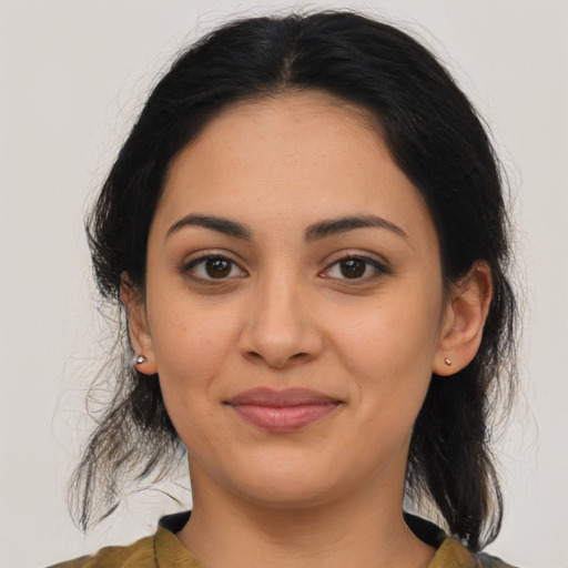 Joyful latino young-adult female with medium  brown hair and brown eyes