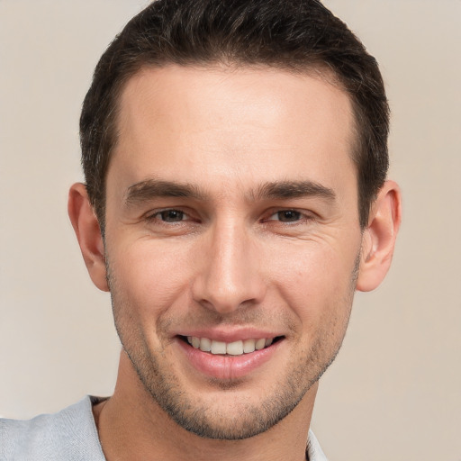 Joyful white young-adult male with short  brown hair and brown eyes