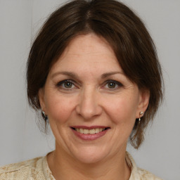 Joyful white adult female with medium  brown hair and brown eyes