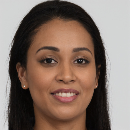 Joyful latino young-adult female with long  brown hair and brown eyes