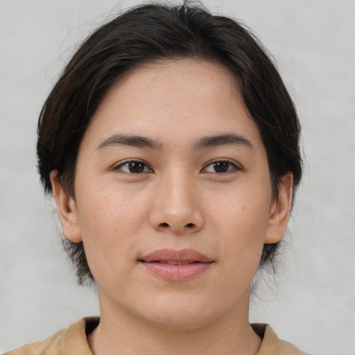 Joyful asian young-adult female with medium  brown hair and brown eyes