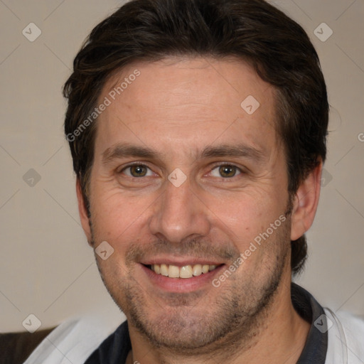 Joyful white adult male with short  brown hair and brown eyes