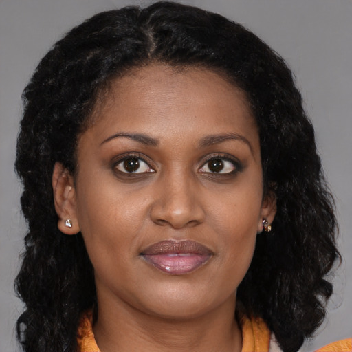 Joyful black young-adult female with medium  brown hair and brown eyes