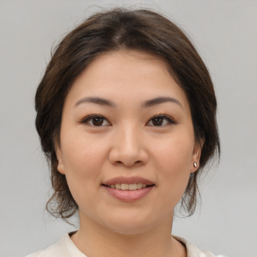 Joyful asian young-adult female with medium  brown hair and brown eyes