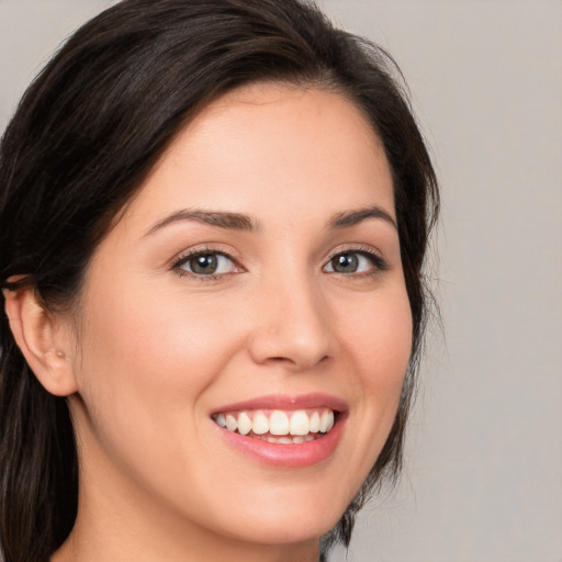 Joyful white young-adult female with medium  brown hair and brown eyes