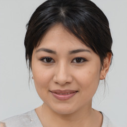 Joyful asian young-adult female with medium  brown hair and brown eyes