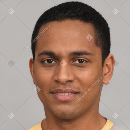 Joyful black young-adult male with short  black hair and brown eyes