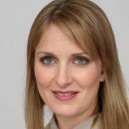 Joyful white young-adult female with long  brown hair and grey eyes