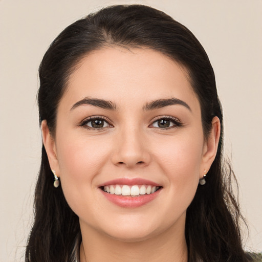 Joyful white young-adult female with long  brown hair and brown eyes