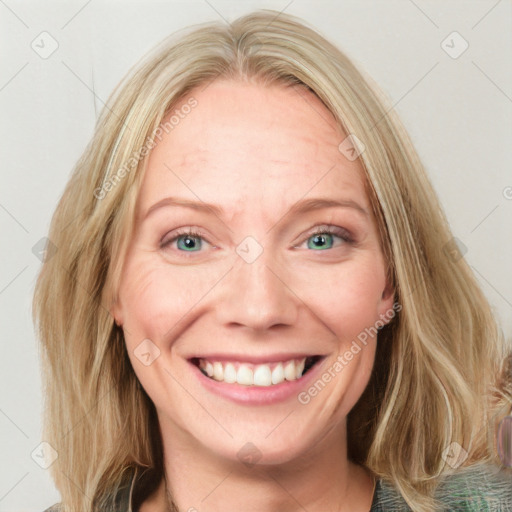 Joyful white adult female with long  brown hair and blue eyes