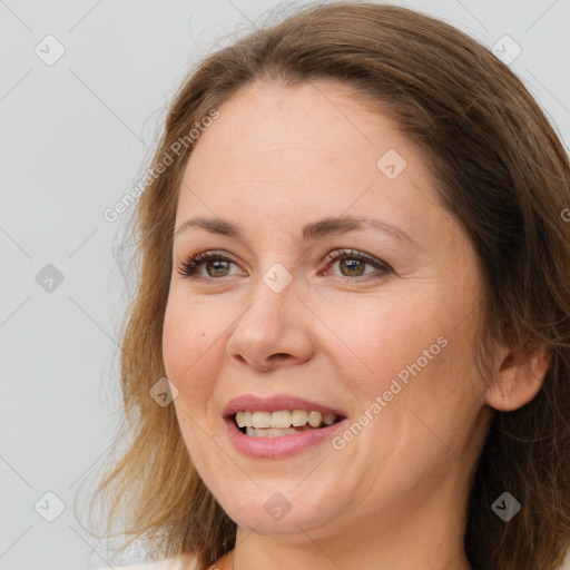 Joyful white adult female with long  brown hair and brown eyes