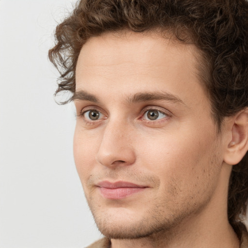 Joyful white young-adult male with short  brown hair and green eyes