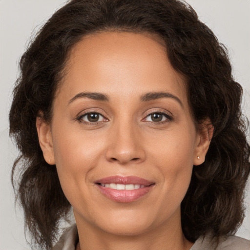 Joyful white adult female with medium  brown hair and brown eyes