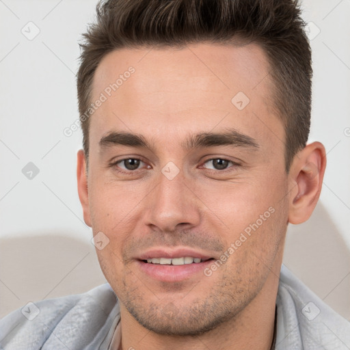 Joyful white young-adult male with short  brown hair and brown eyes