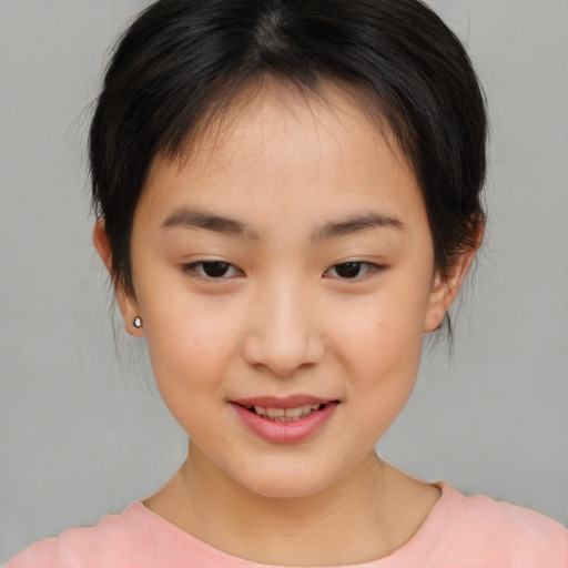 Joyful asian child female with medium  brown hair and brown eyes