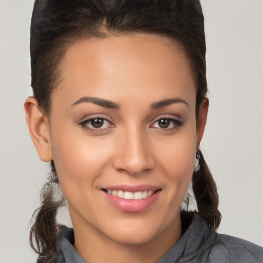 Joyful white young-adult female with long  brown hair and brown eyes