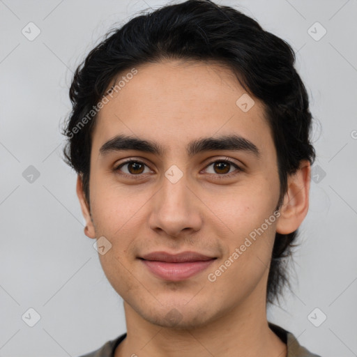 Joyful latino young-adult male with short  brown hair and brown eyes