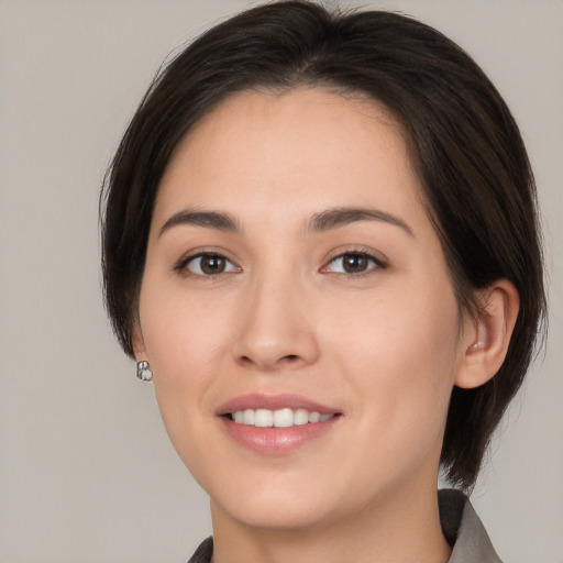 Joyful white young-adult female with medium  brown hair and brown eyes