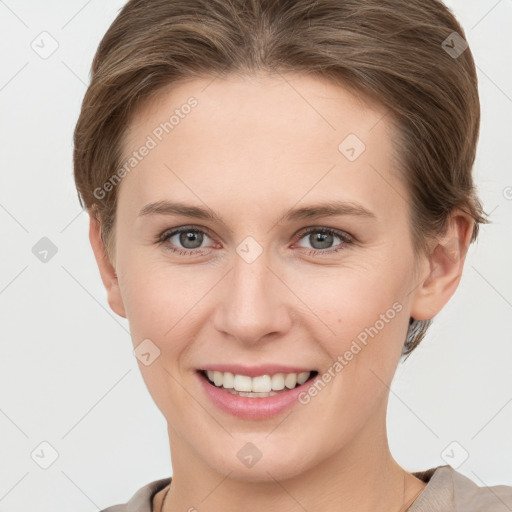 Joyful white young-adult female with short  brown hair and grey eyes