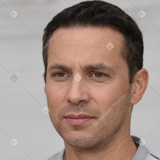 Joyful white adult male with short  black hair and brown eyes