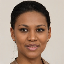 Joyful black young-adult female with short  black hair and brown eyes