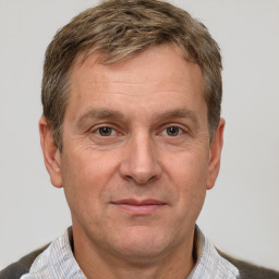 Joyful white adult male with short  brown hair and grey eyes