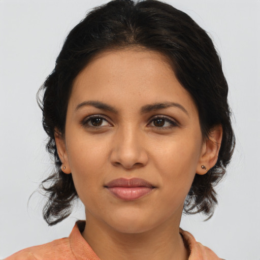 Joyful latino young-adult female with medium  brown hair and brown eyes