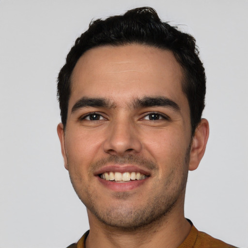 Joyful white young-adult male with short  black hair and brown eyes