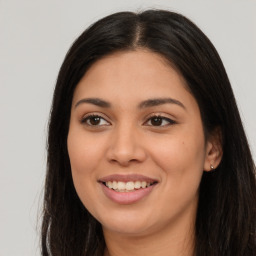 Joyful latino young-adult female with long  brown hair and brown eyes