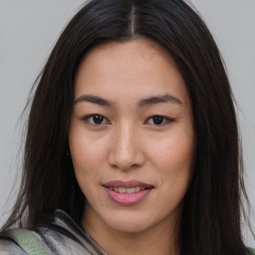 Joyful asian young-adult female with long  brown hair and brown eyes
