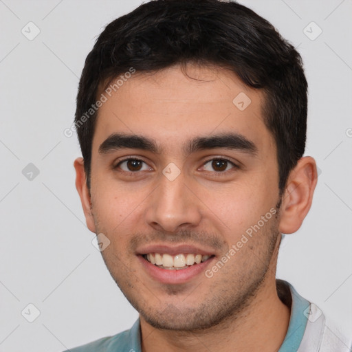 Joyful white young-adult male with short  black hair and brown eyes